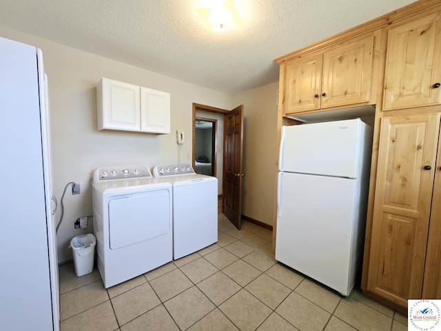 502 S Ferguson Ave, Tipton, MO 65081 - clothes washing area featuring light tile patterned floors, a textured ceiling, cabinet space, and washer and dryer