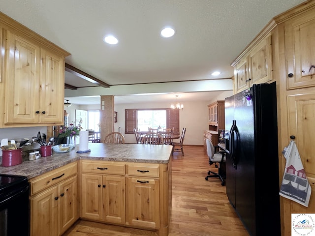 502 S Ferguson Ave, Tipton, MO 65081 - kitchen with a peninsula, light wood-style floors, black appliances, and light brown cabinets