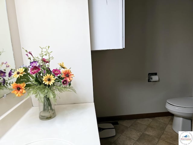 502 S Ferguson Ave, Tipton, MO 65081 - bathroom with baseboards and toilet