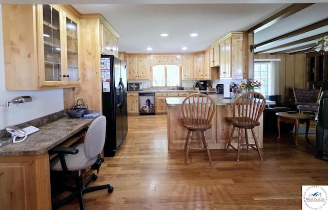 502 S Ferguson Ave, Tipton, MO 65081 - kitchen featuring light brown cabinetry, dishwasher, stainless steel microwave, a peninsula, and black refrigerator with ice dispenser