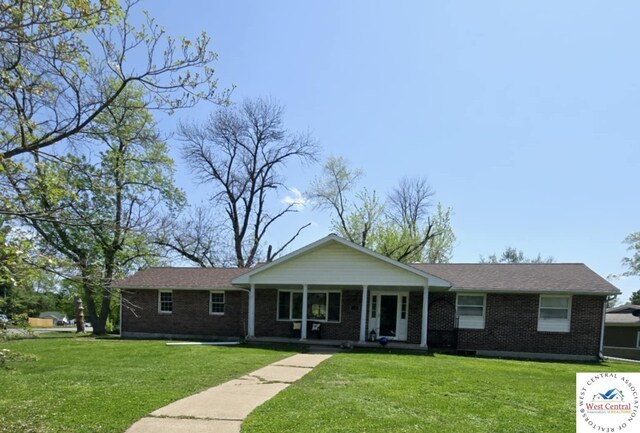 502 S Ferguson Ave, Tipton, MO 65081 - ranch-style home featuring covered porch, brick siding, and a front lawn