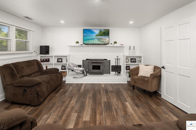 321 E 17th St, Sedalia, MO 65301 - living area featuring dark wood-type flooring, a brick fireplace, and recessed lighting