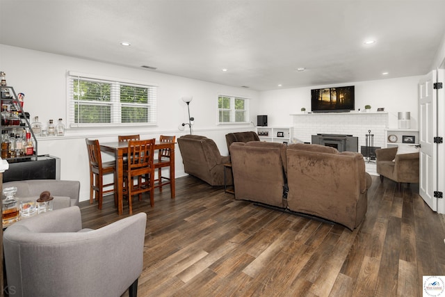 321 E 17th St, Sedalia, MO 65301 - living room featuring dark wood-style flooring, recessed lighting, and a brick fireplace
