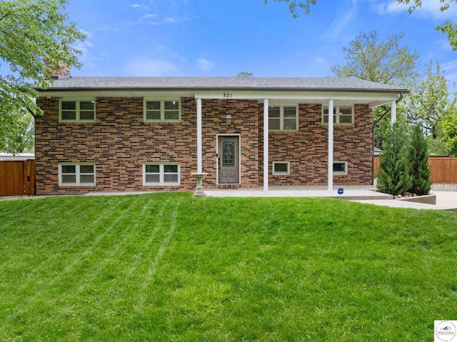 321 E 17th St, Sedalia, MO 65301 - rear view of house with brick siding, a patio area, and a chimney