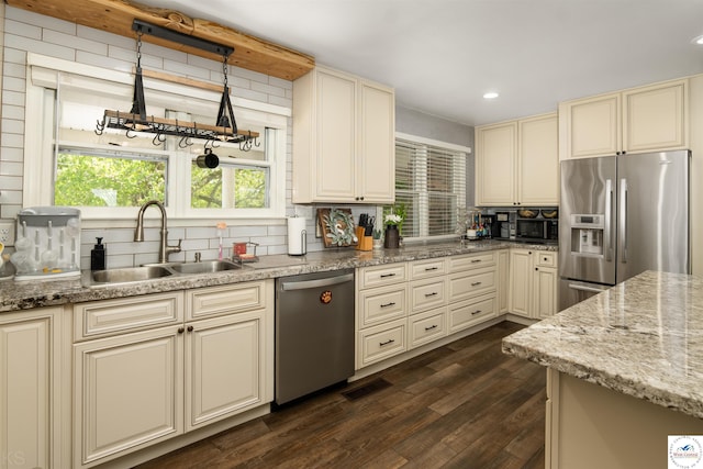 321 E 17th St, Sedalia, MO 65301 - kitchen featuring cream cabinetry, stainless steel appliances, a sink, tasteful backsplash, and recessed lighting