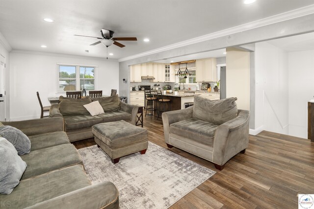 321 E 17th St, Sedalia, MO 65301 - living area featuring ceiling fan, dark wood-style flooring, recessed lighting, baseboards, and crown molding