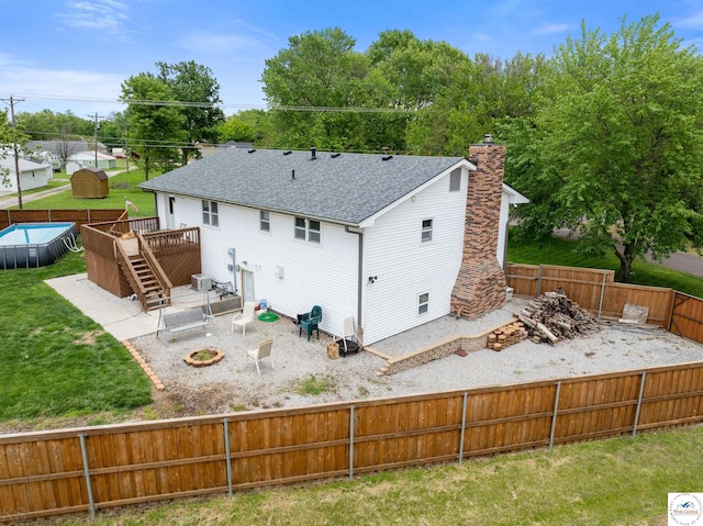 321 E 17th St, Sedalia, MO 65301 - rear view of property featuring a wooden deck, a chimney, a shingled roof, stairs, and a patio area