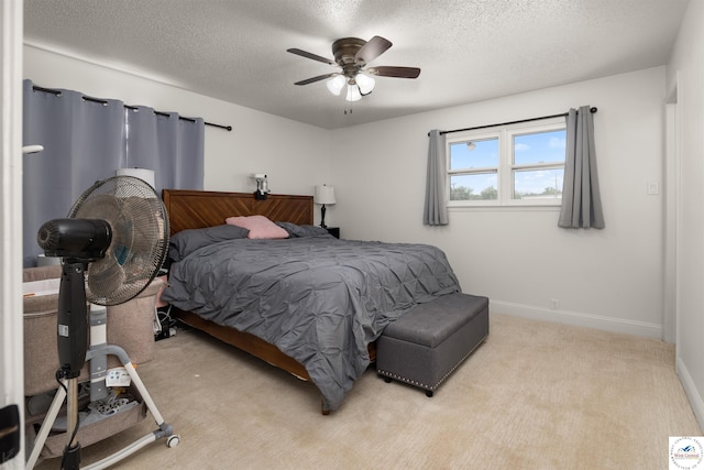 321 E 17th St, Sedalia, MO 65301 - bedroom with a textured ceiling, light carpet, a ceiling fan, and baseboards