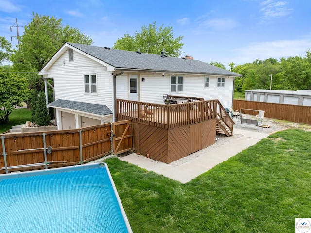 321 E 17th St, Sedalia, MO 65301 - back of house featuring a wooden deck, a shingled roof, an attached garage, a gate, and a chimney