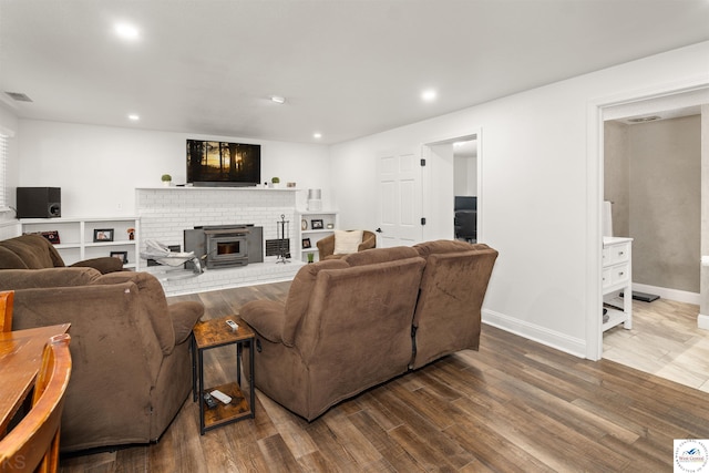 321 E 17th St, Sedalia, MO 65301 - living area featuring a brick fireplace, wood finished floors, baseboards, and recessed lighting