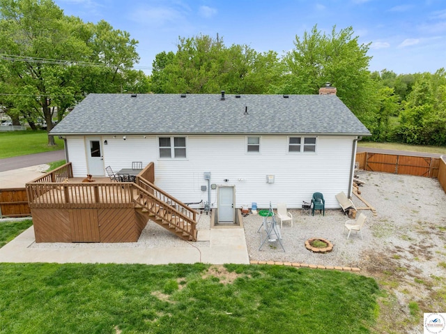 321 E 17th St, Sedalia, MO 65301 - back of property featuring a wooden deck, a patio area, a shingled roof, and a chimney