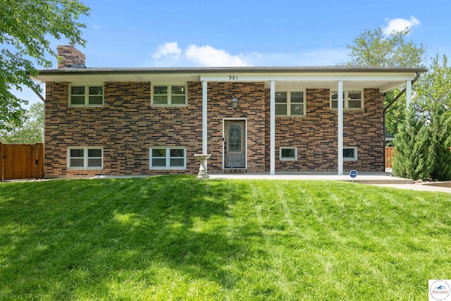321 E 17th St, Sedalia, MO 65301 - rear view of house featuring a chimney, brick siding, a patio, and a gate