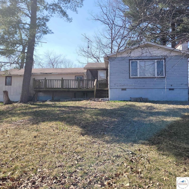exterior space featuring a wooden deck, a front lawn, and crawl space