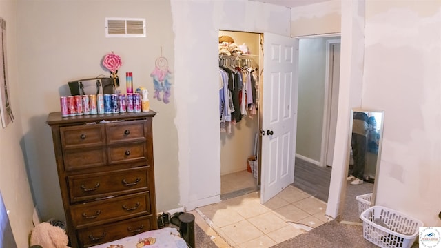 715 Hickory St, Warsaw, MO 65355 - bedroom featuring light tile patterned floors, a closet, and a walk in closet