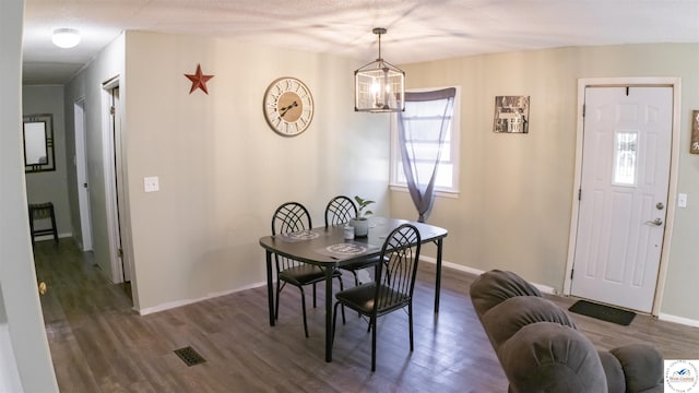 715 Hickory St, Warsaw, MO 65355 - dining space with dark wood-style floors, a chandelier, and baseboards