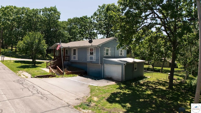 715 Hickory St, Warsaw, MO 65355 - ranch-style house featuring driveway, a garage, and stairs