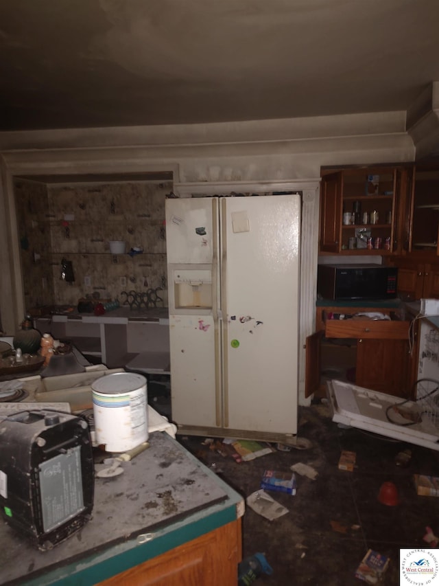 kitchen with black microwave, white fridge with ice dispenser, and open shelves