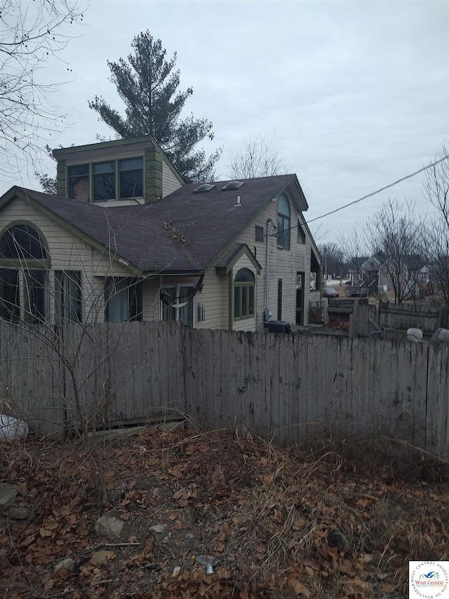 view of property exterior featuring fence