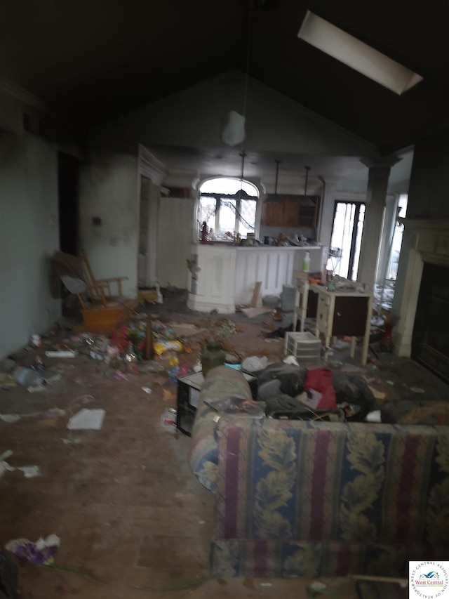 living room with decorative columns and a fireplace