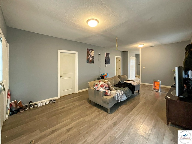 living area featuring baseboards and wood finished floors