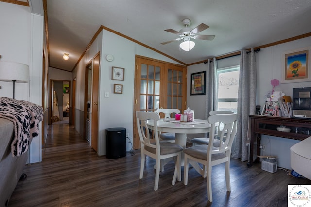 dining space featuring dark wood-type flooring, a ceiling fan, lofted ceiling, and crown molding
