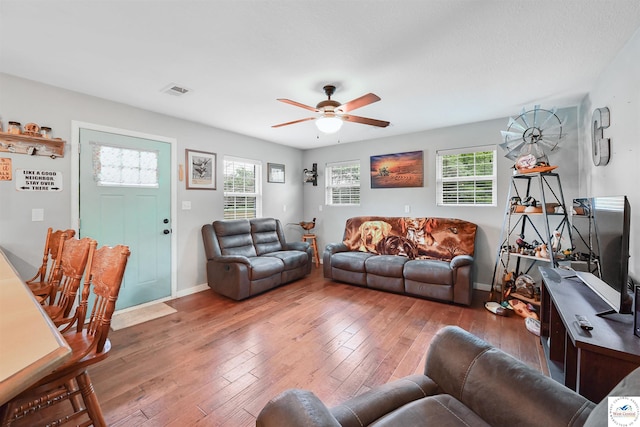810 Harris St, Clinton, MO 64735 - living area with a ceiling fan, hardwood / wood-style flooring, healthy amount of natural light, and baseboards