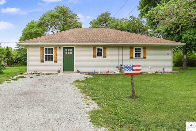 810 Harris St, Clinton, MO 64735 - view of front of home with a front lawn, driveway, and a shingled roof