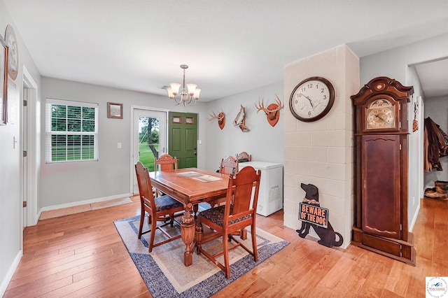 810 Harris St, Clinton, MO 64735 - dining space featuring a chandelier, light wood-style floors, and baseboards