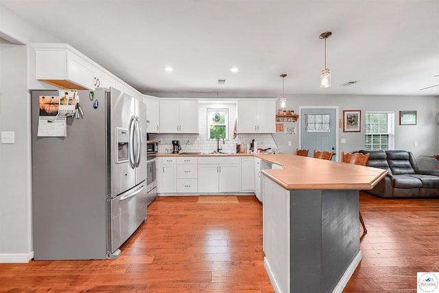 810 Harris St, Clinton, MO 64735 - kitchen with stainless steel appliances, a peninsula, open floor plan, healthy amount of natural light, and recessed lighting