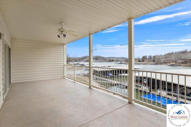 view of patio with a ceiling fan, a balcony, and a water view