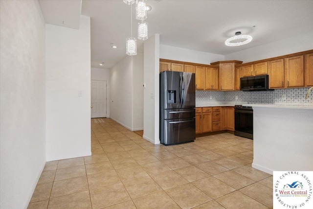 kitchen with light tile patterned floors, light countertops, black refrigerator with ice dispenser, brown cabinetry, and backsplash