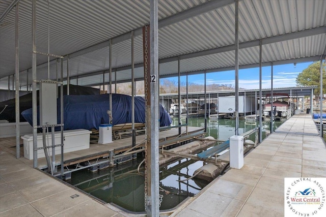 dock area with a water view and boat lift