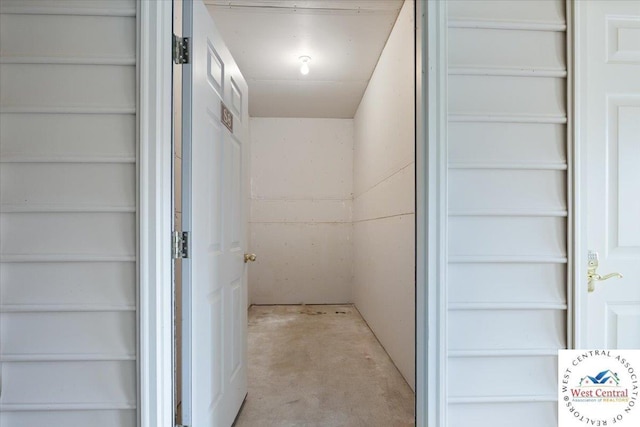 corridor with unfinished concrete floors