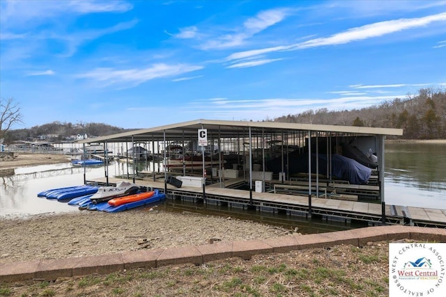 view of dock with boat lift and a water view
