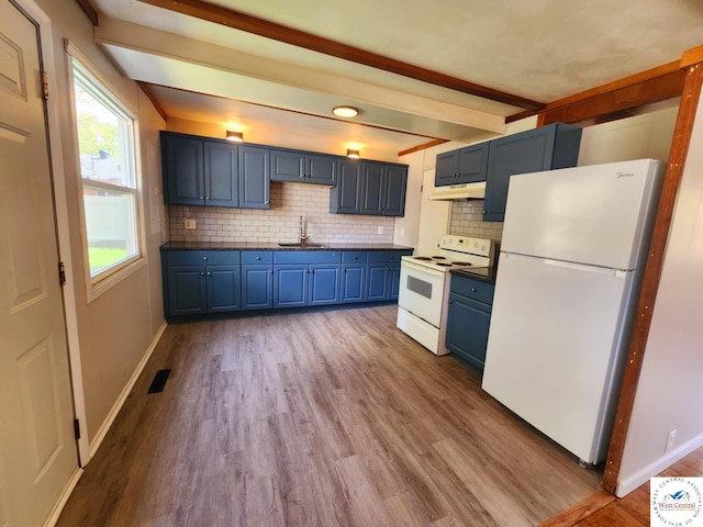 705-709 S Park Ave, Sedalia, MO 65301 - kitchen featuring white appliances, blue cabinetry, a sink, under cabinet range hood, and dark countertops