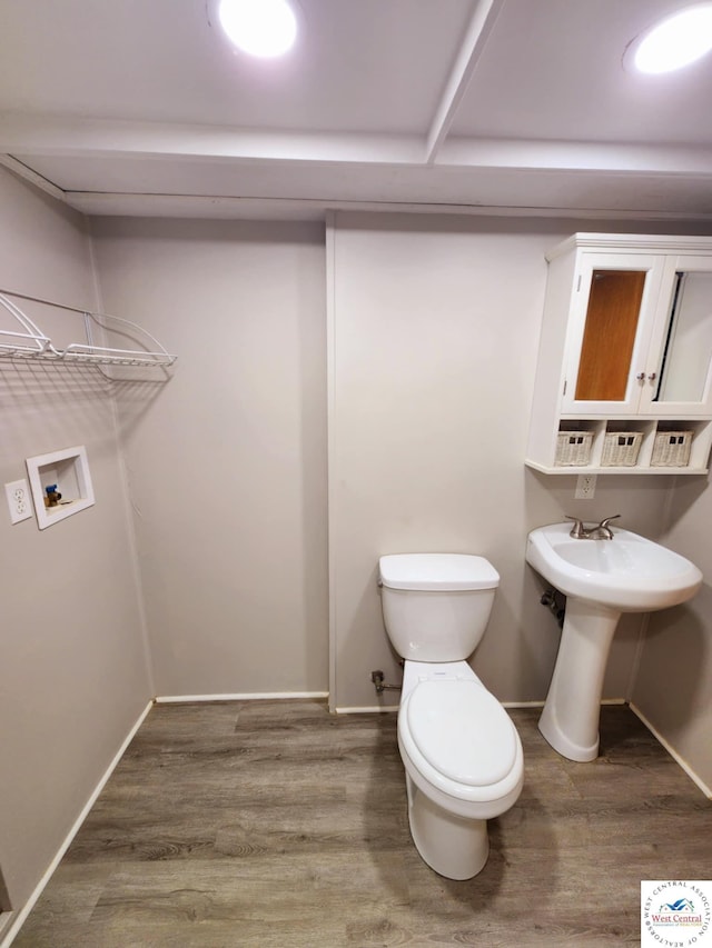 705-709 S Park Ave, Sedalia, MO 65301 - half bath with toilet, wood finished floors, baseboards, and a sink