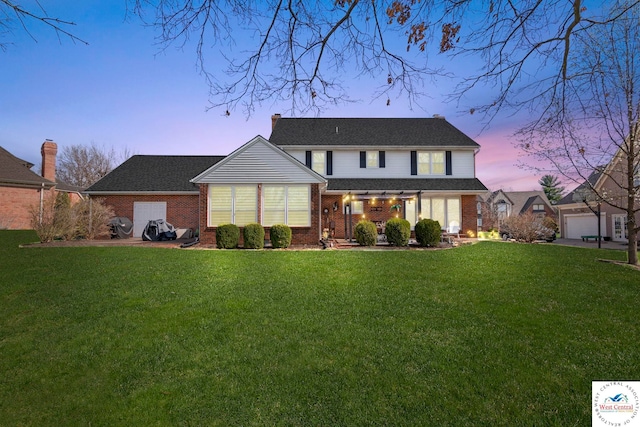 view of front of property with brick siding and a front lawn