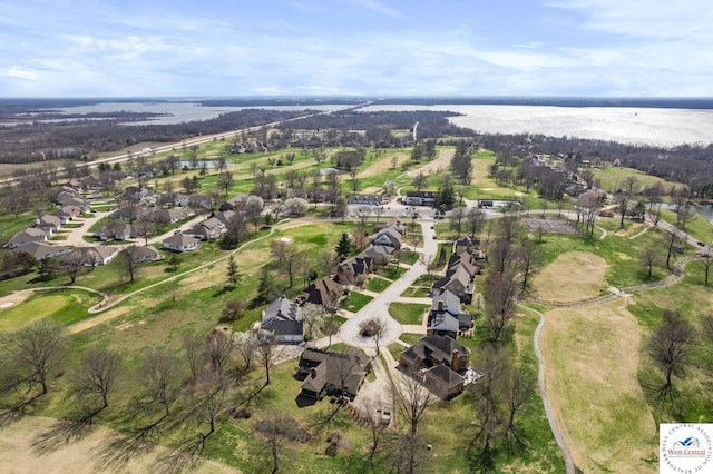 aerial view with golf course view, a residential view, and a water view