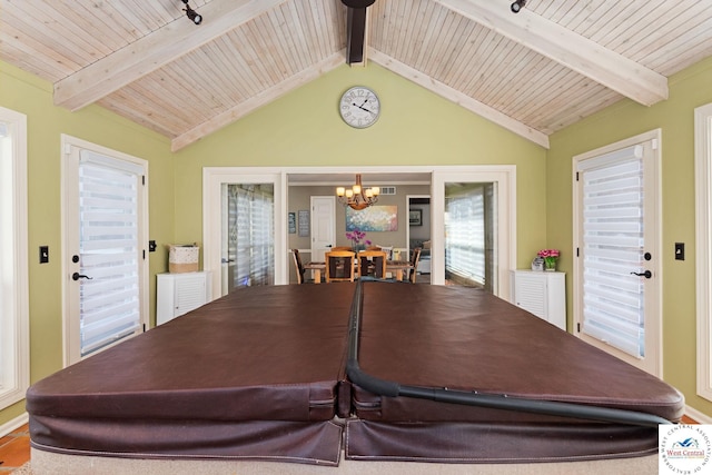 dining area with lofted ceiling with beams, a notable chandelier, and wood ceiling