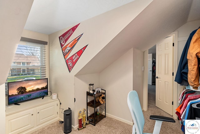carpeted office with baseboards and vaulted ceiling