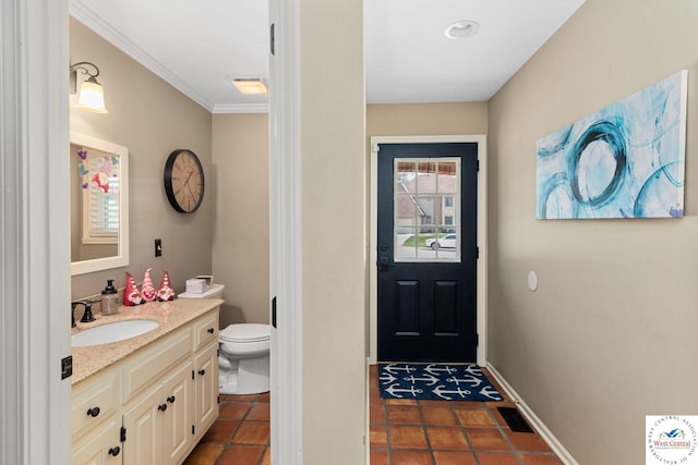 bathroom with vanity, toilet, and crown molding