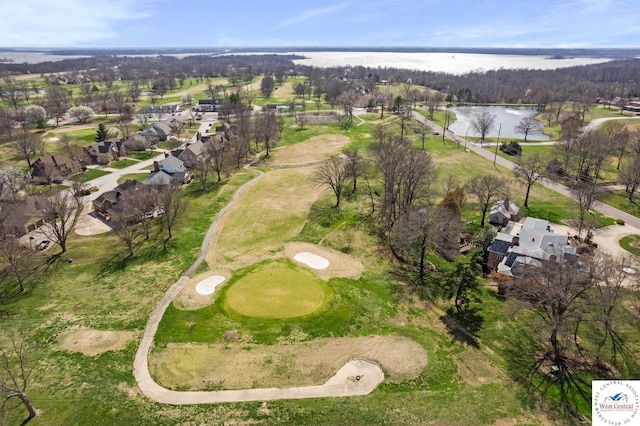 drone / aerial view with a water view, a residential view, and view of golf course