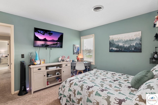 carpeted bedroom featuring visible vents