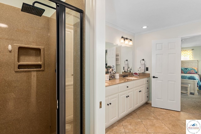 ensuite bathroom with connected bathroom, tile patterned flooring, vanity, a stall shower, and crown molding
