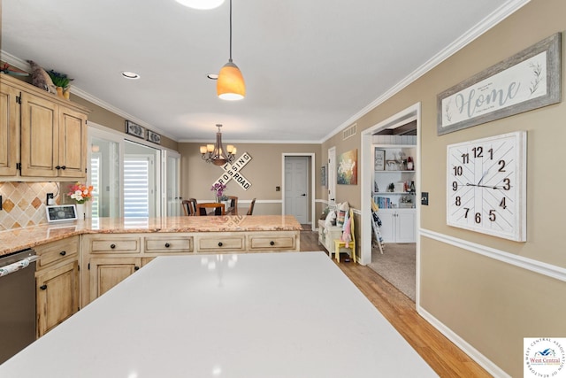 kitchen with a chandelier, light countertops, dishwasher, light wood finished floors, and crown molding