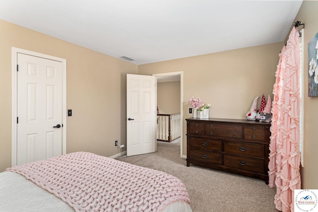bedroom featuring visible vents, light colored carpet, and baseboards