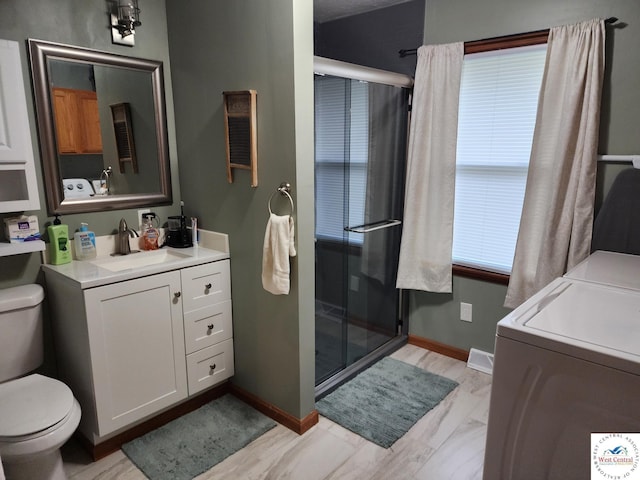 810 E Cedar St, Clinton, MO 64735 - bathroom featuring washer and clothes dryer, toilet, a shower stall, vanity, and baseboards