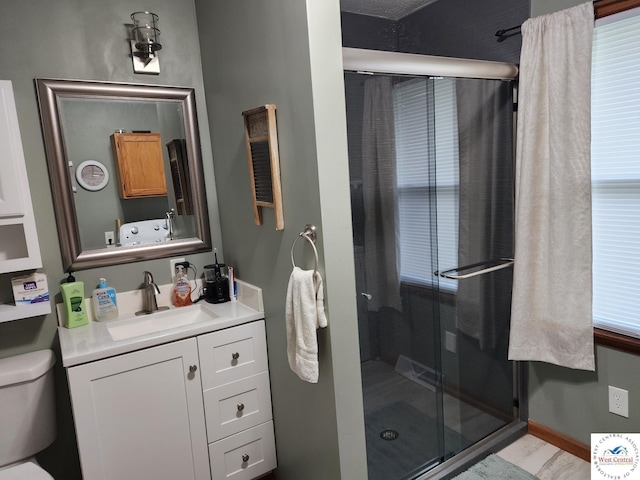 810 E Cedar St, Clinton, MO 64735 - bathroom with vanity, a shower stall, and toilet