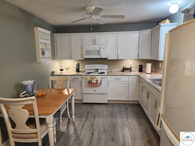 810 E Cedar St, Clinton, MO 64735 - kitchen with white appliances, ceiling fan, white cabinetry, light wood-style flooring, and a textured ceiling