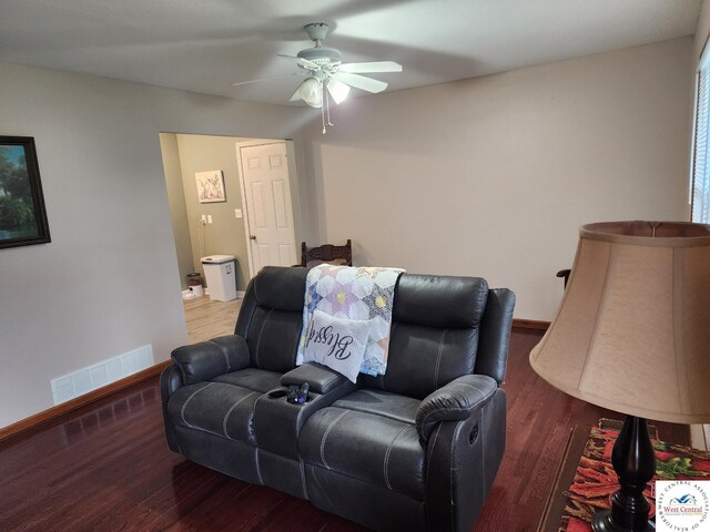 810 E Cedar St, Clinton, MO 64735 - living area with a ceiling fan, wood finished floors, and baseboards